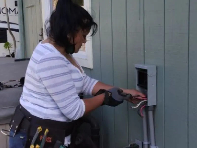 Licensed electrician wiring an exterior subpanel in Yountville